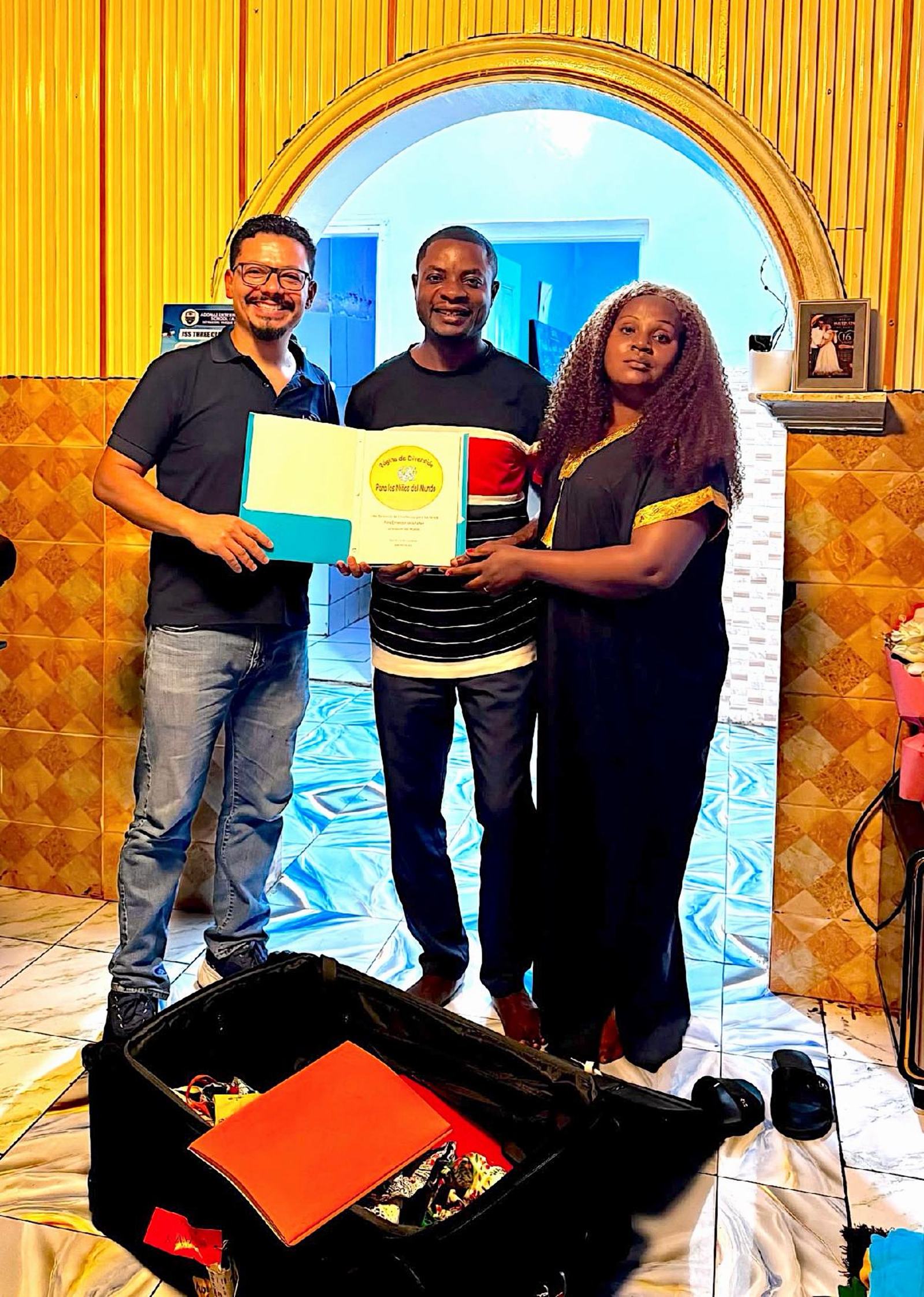 September 2026 Pastor Tony presenting gifts to Impacto Africa's Director aleluya